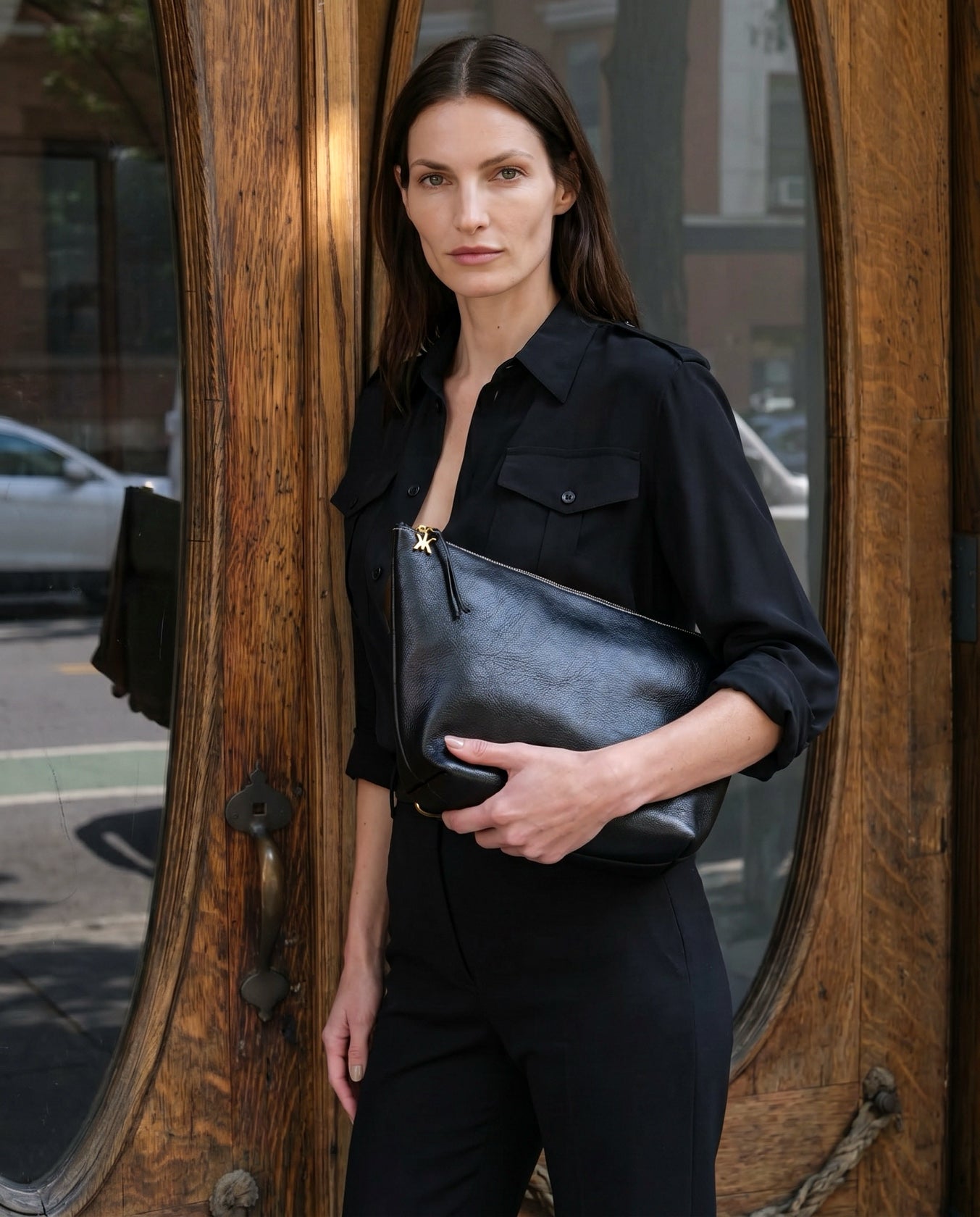 Carried on its own, the pouch holds the essentials with quiet precision.