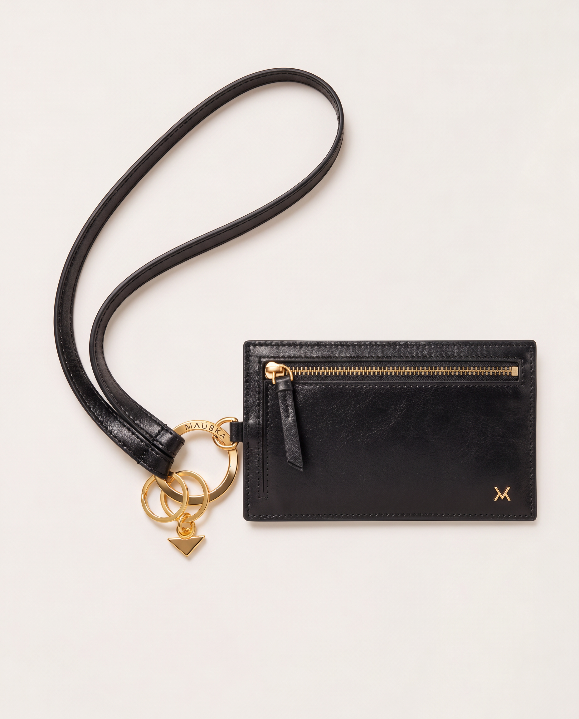 MAUSKA ARO black leather key holder attached to the matching ARO wallet with gold-tone hardware.