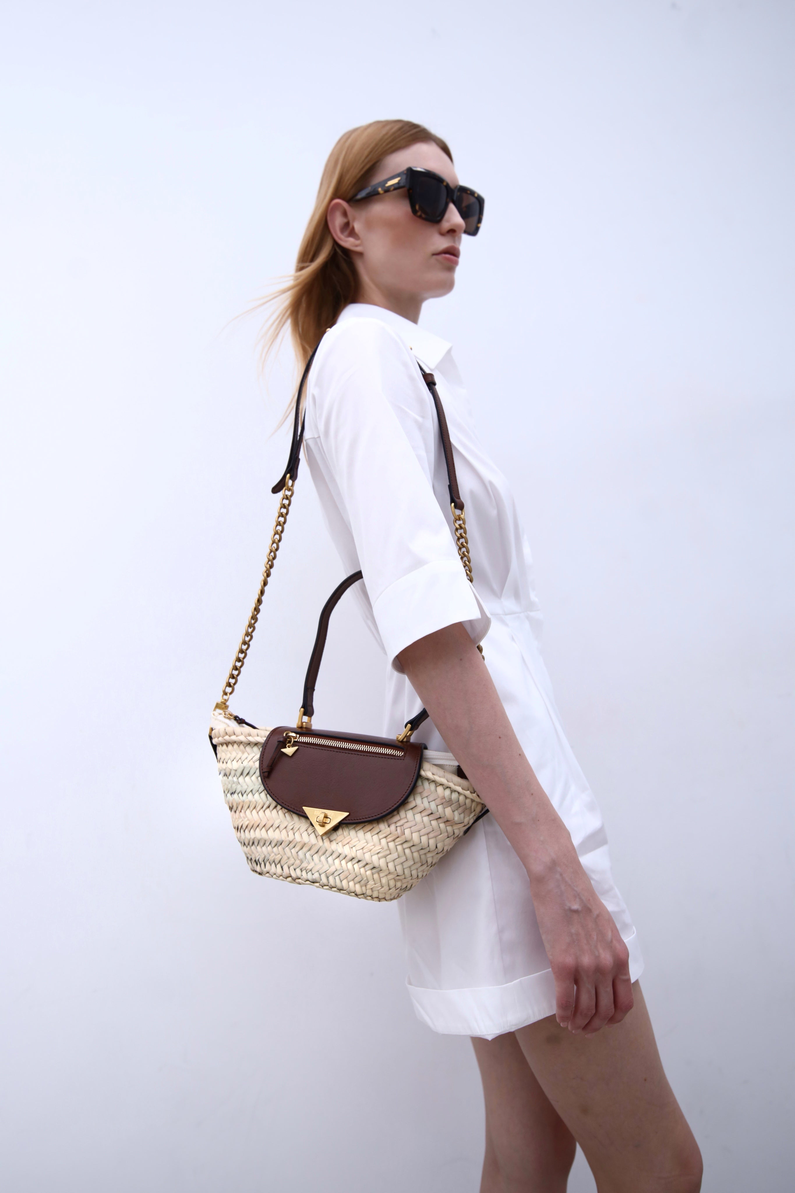 Majorelle hazelnut basket bag with handle worn on model by Mauska. Designed in San Sebastián and handcrafted in Ubrique, Spain. Defined by texture and contemporary design.