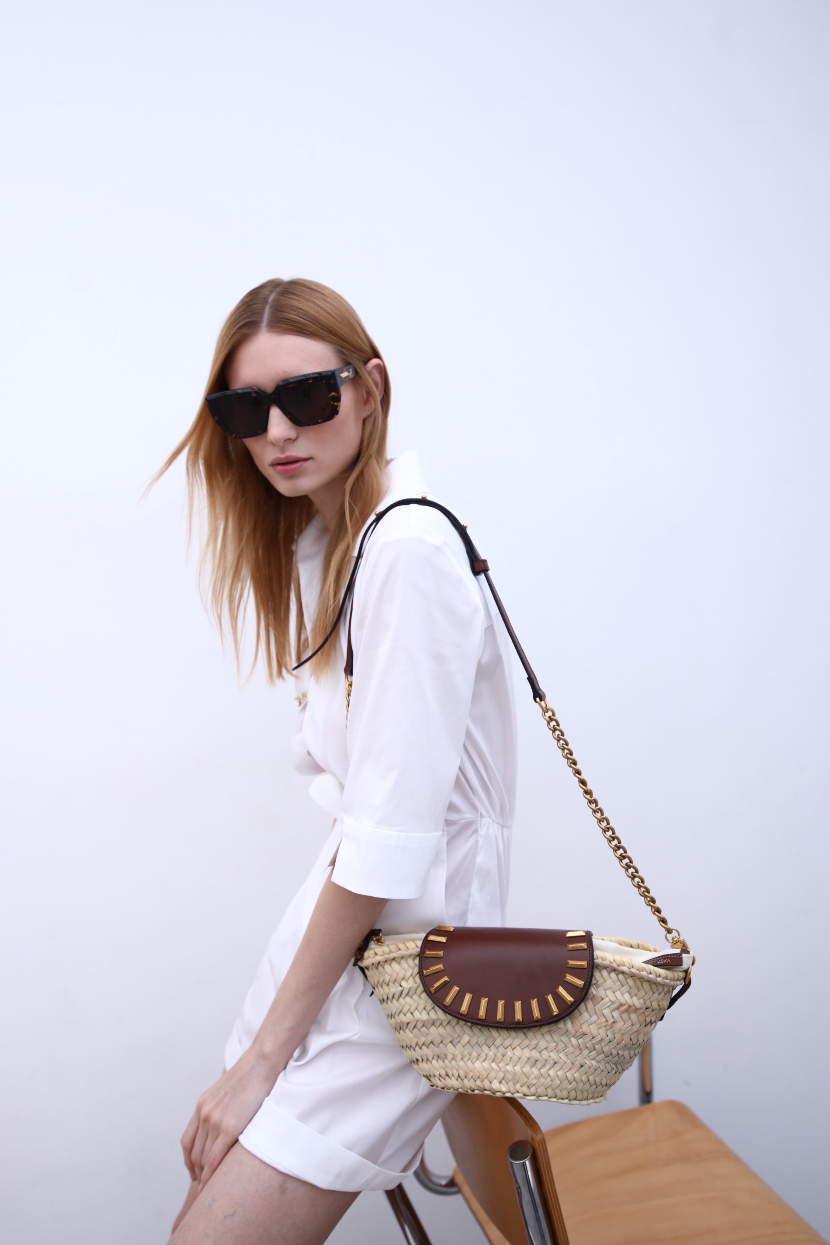 Majorelle hazelnut studded basket bag worn on model by Mauska. Designed in San Sebastián and handcrafted in Ubrique, Spain. Defined by texture and contemporary design.