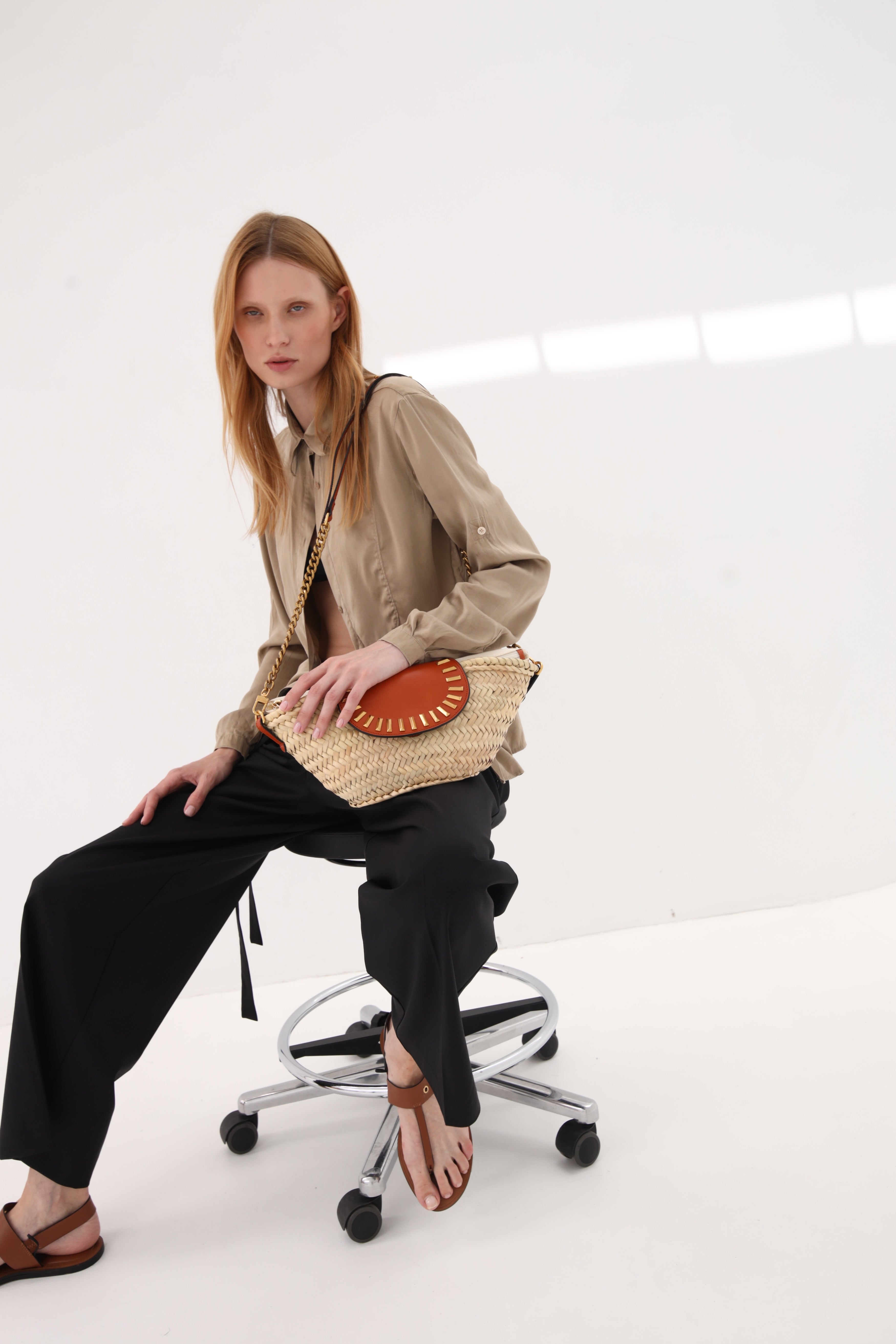 Majorelle honey studded basket bag worn on model by Mauska. Designed in San Sebastián and handcrafted in Ubrique, Spain. Defined by texture and contemporary design.