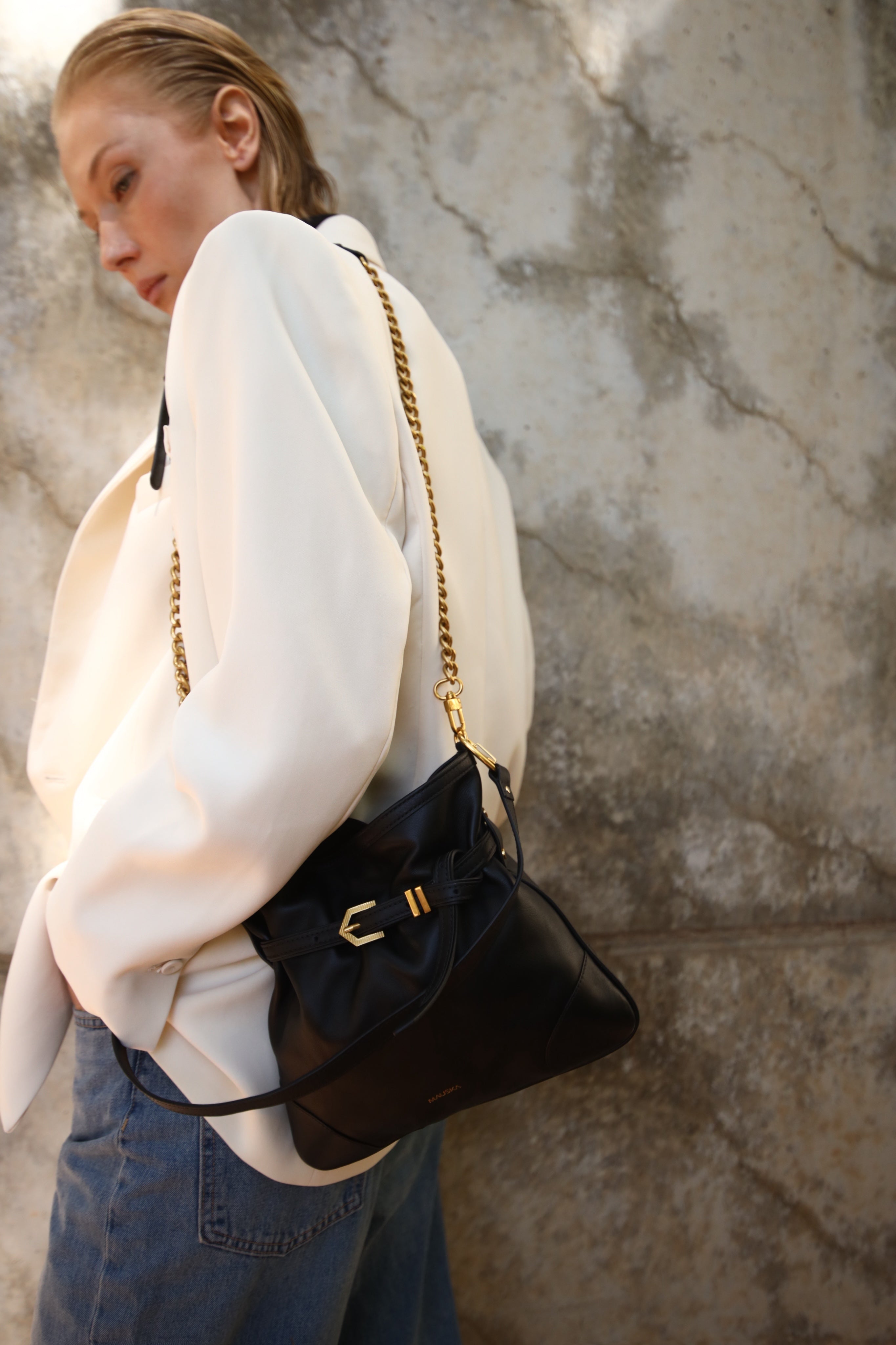 Pereira Mini black suede bag worn on model by Mauska. Designed in San Sebastián and handcrafted in Ubrique, Spain. Defined by texture and contemporary design.