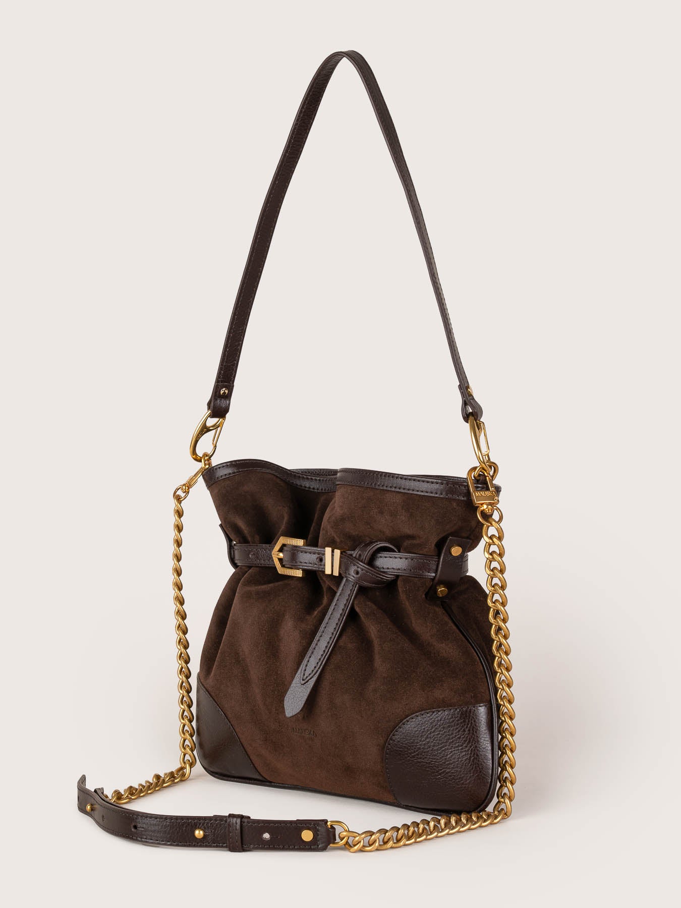 Side view of the Pereira Mini bag in ebony suede leather by Mauska. Designed in San Sebastián and handcrafted in Ubrique, Spain. Defined by texture and contemporary design.