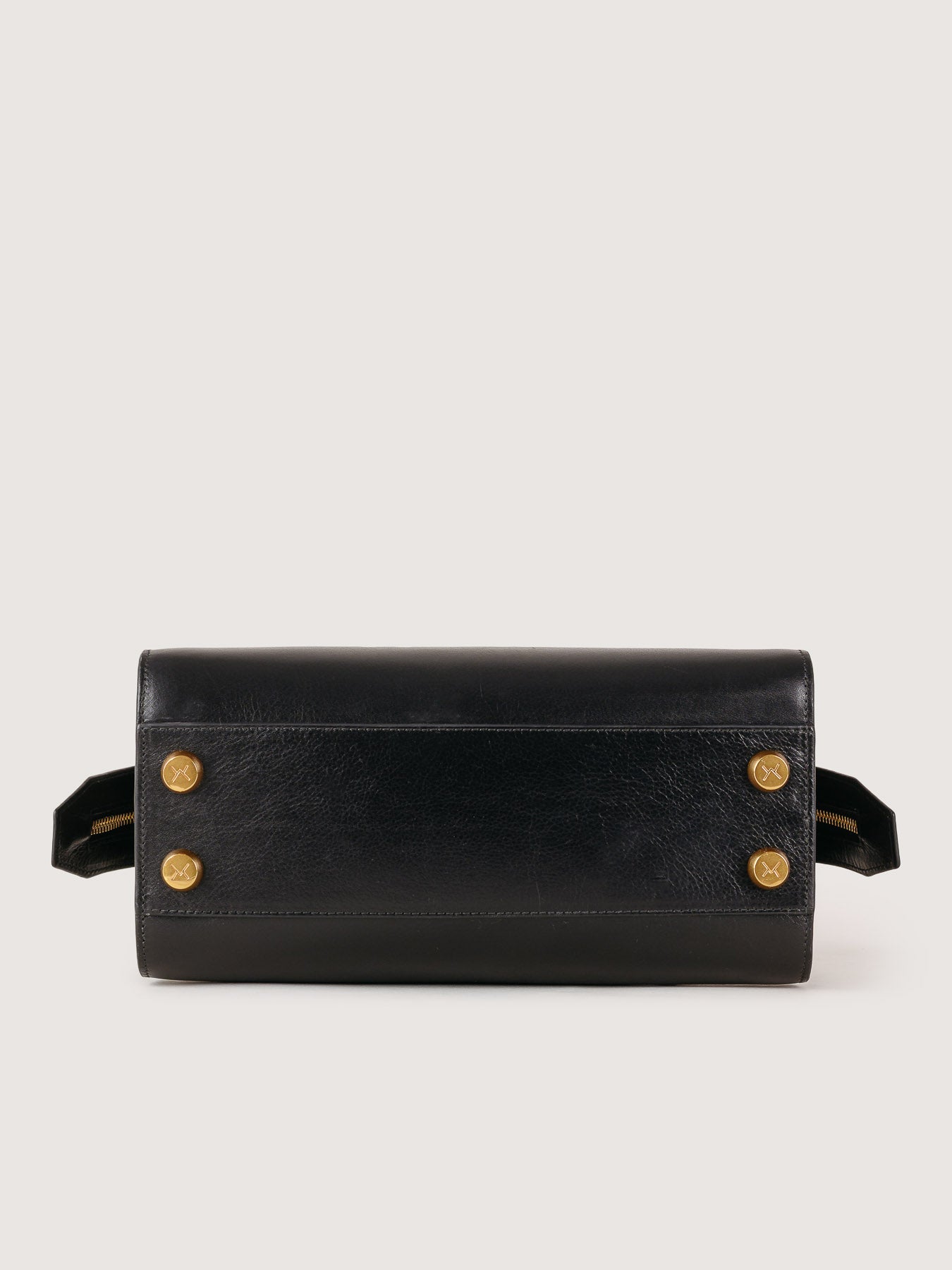 Black Rosario leather bag base detail, handcrafted in Spain