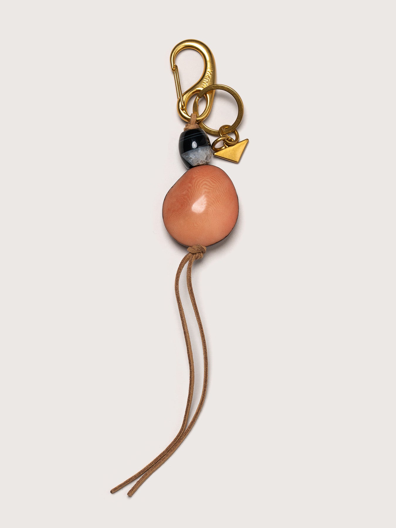 Detail of the Tagua leather key charm by Mauska. Luxury micro-leather accessory designed in San Sebastián and handcrafted by master artisans in Ubrique, Spain. Showcasing premium leather quality and high-end hardware finish.