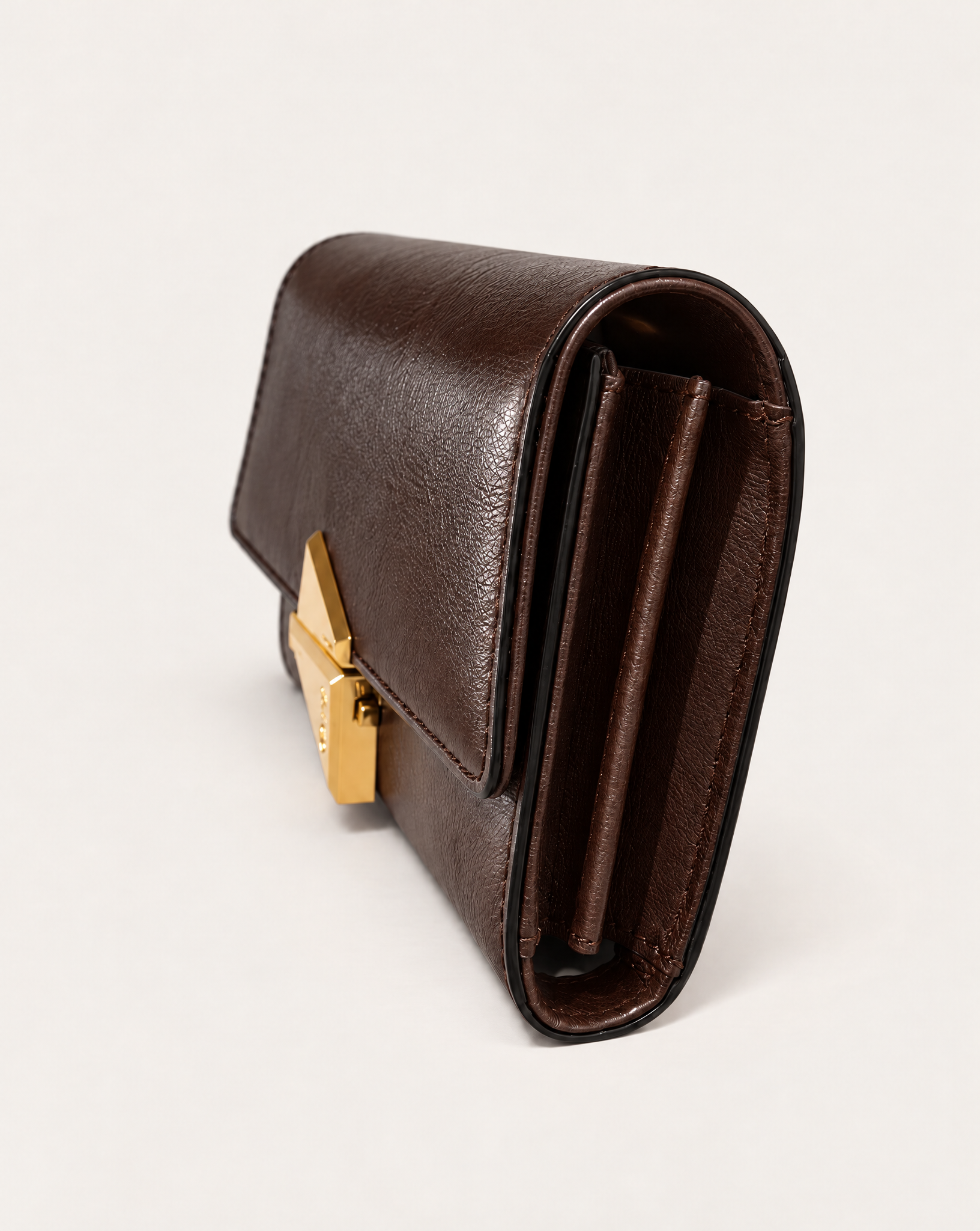 Side view of the VEGA tobacco leather clutch bag by MAUSKA