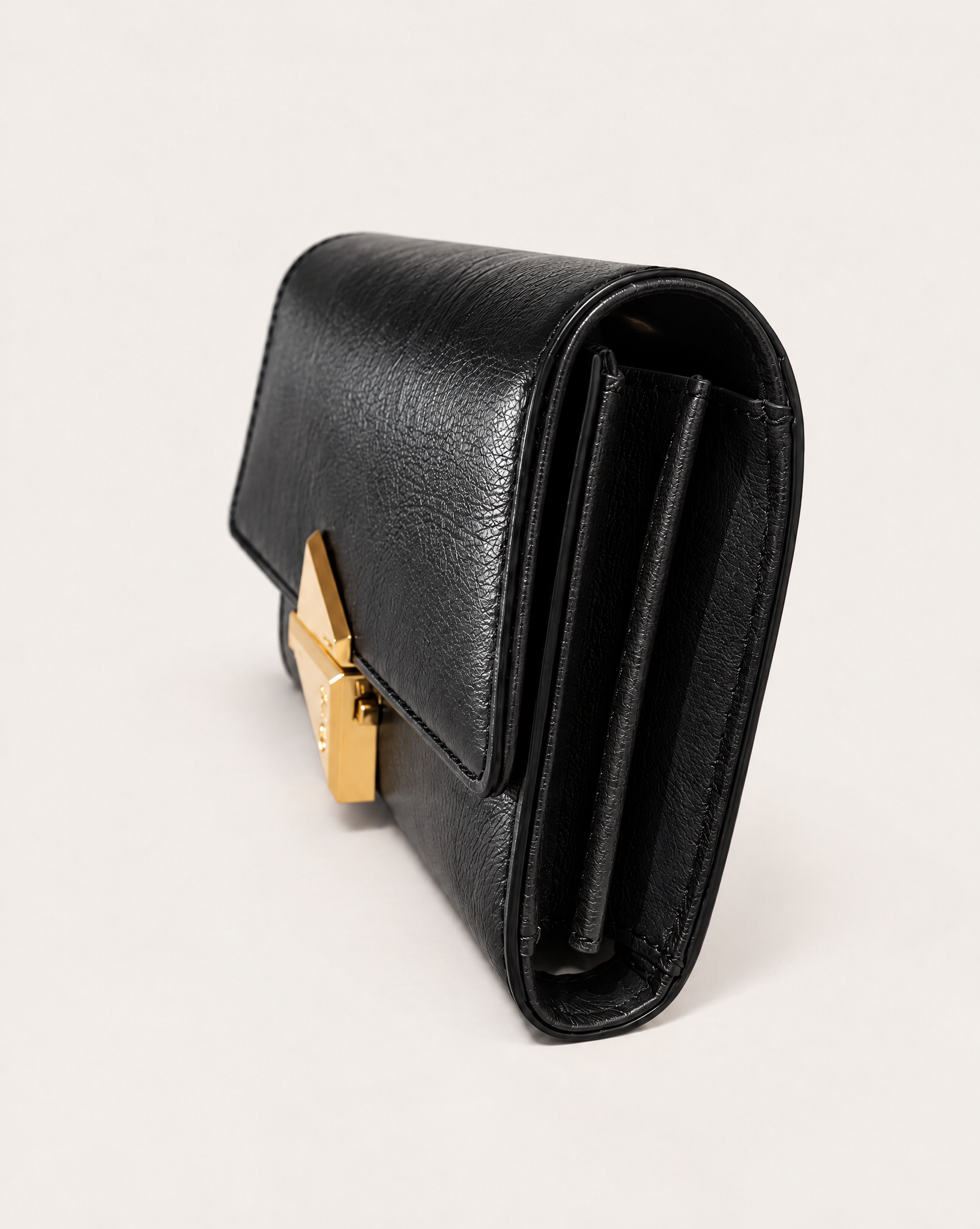Side view of the VEGA black leather clutch bag by MAUSKA