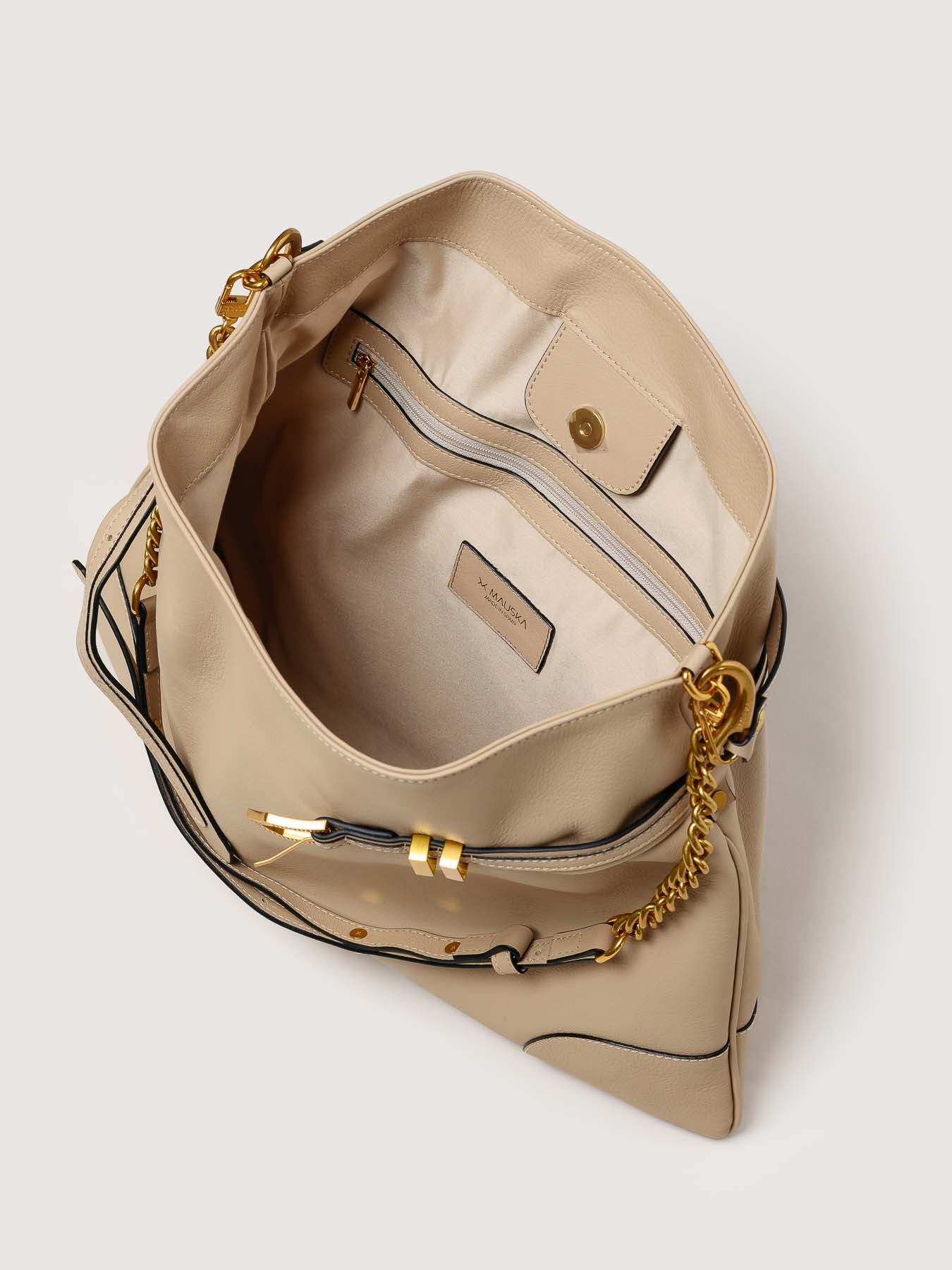 Interior of Pereira Maxi beige leather bag with functional compartments.