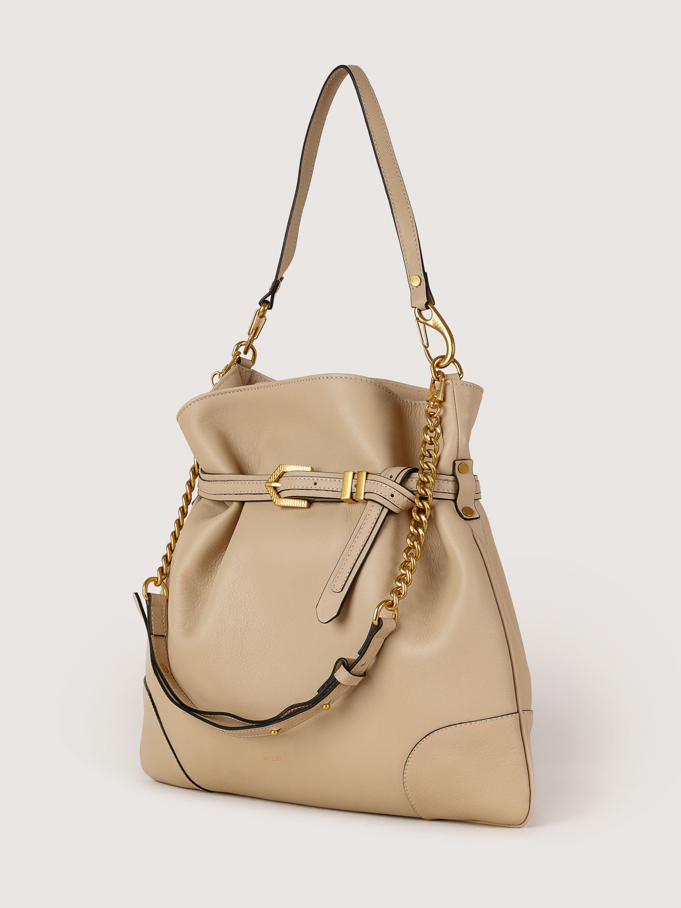 Side view of Pereira Maxi beige leather bag showing its structured silhouette.