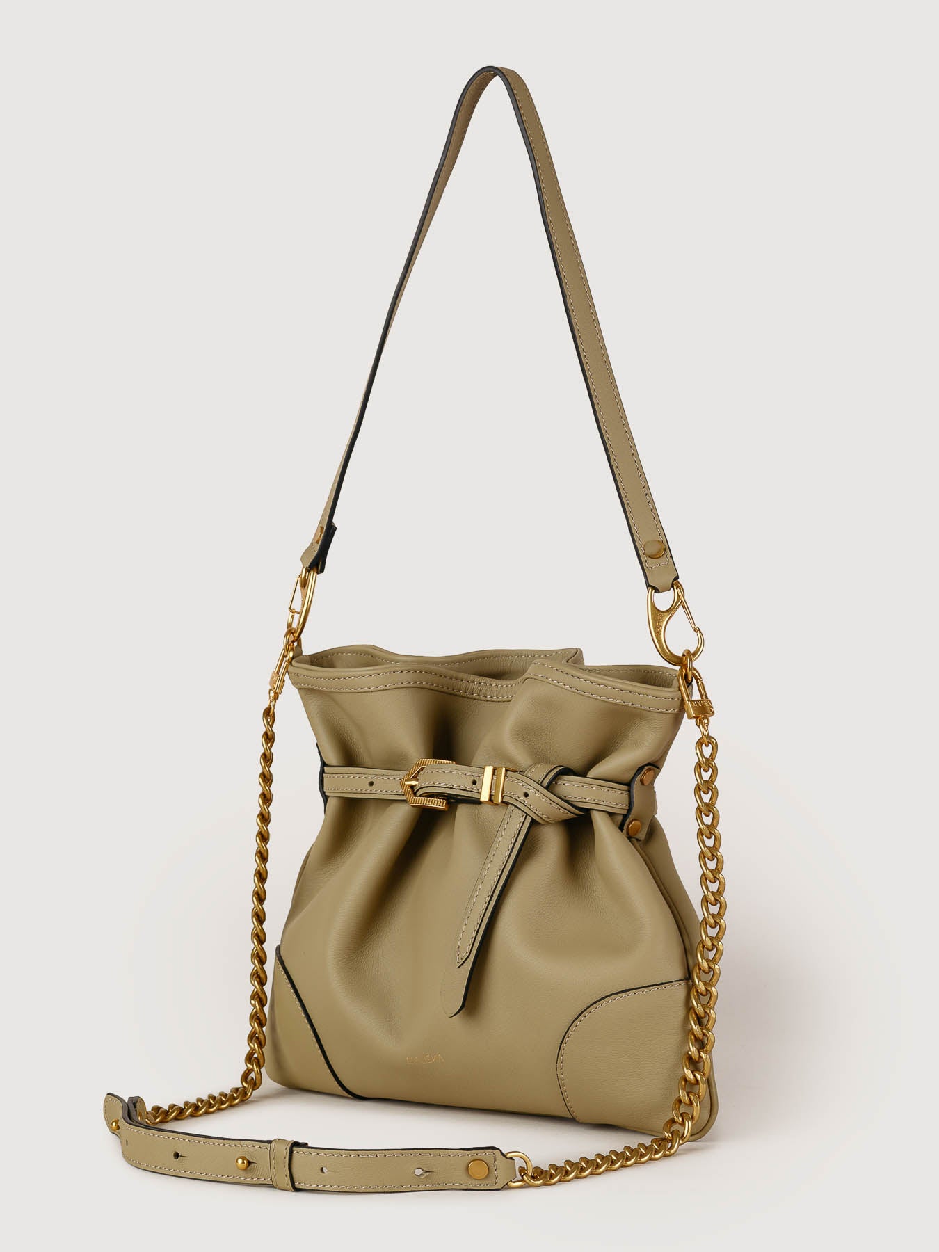 Side view of Pereira Mini light olive leather bag showing its structured silhouette.