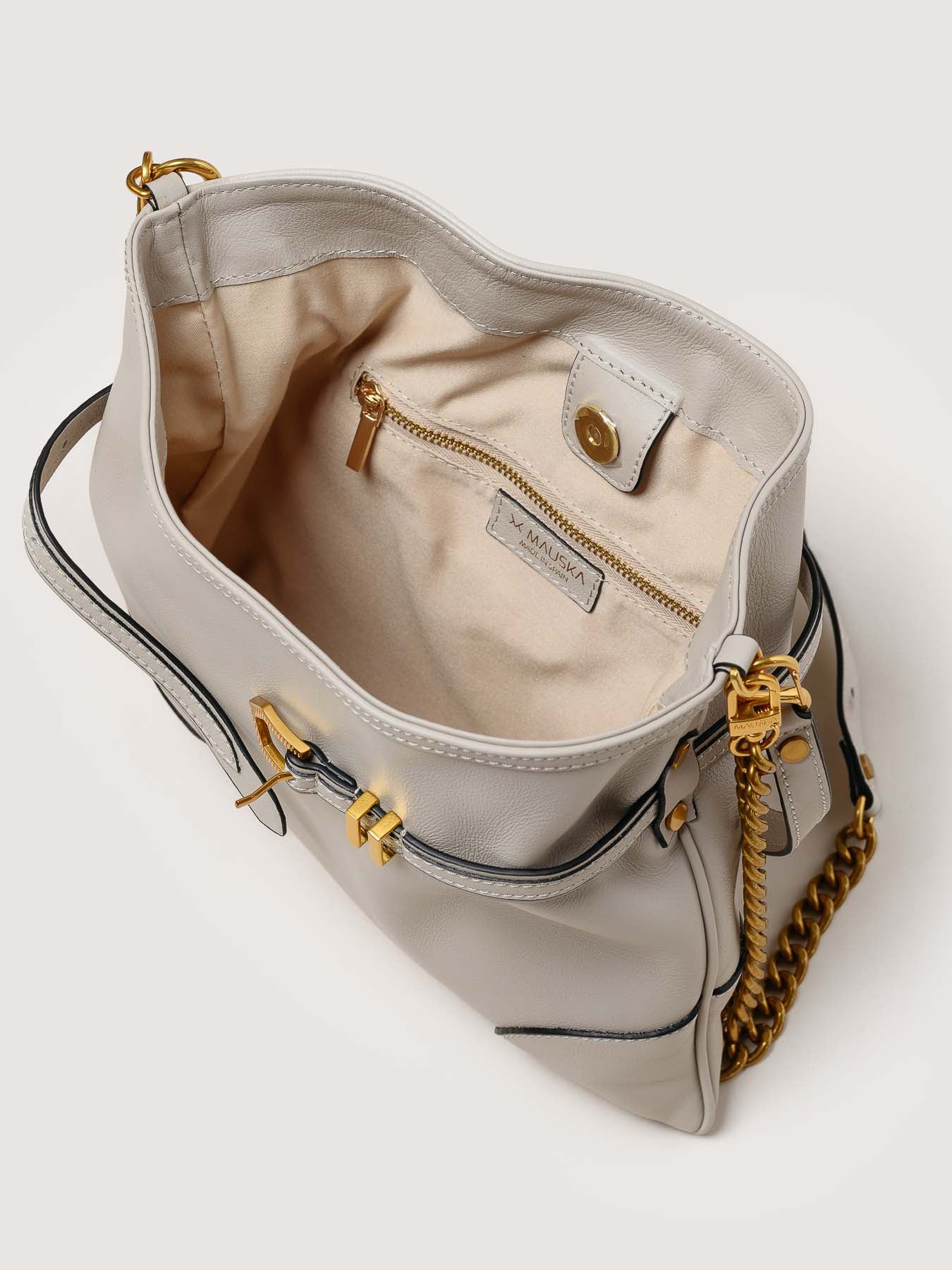 Interior of Pereira Mini pearl grey leather bag with functional compartments.