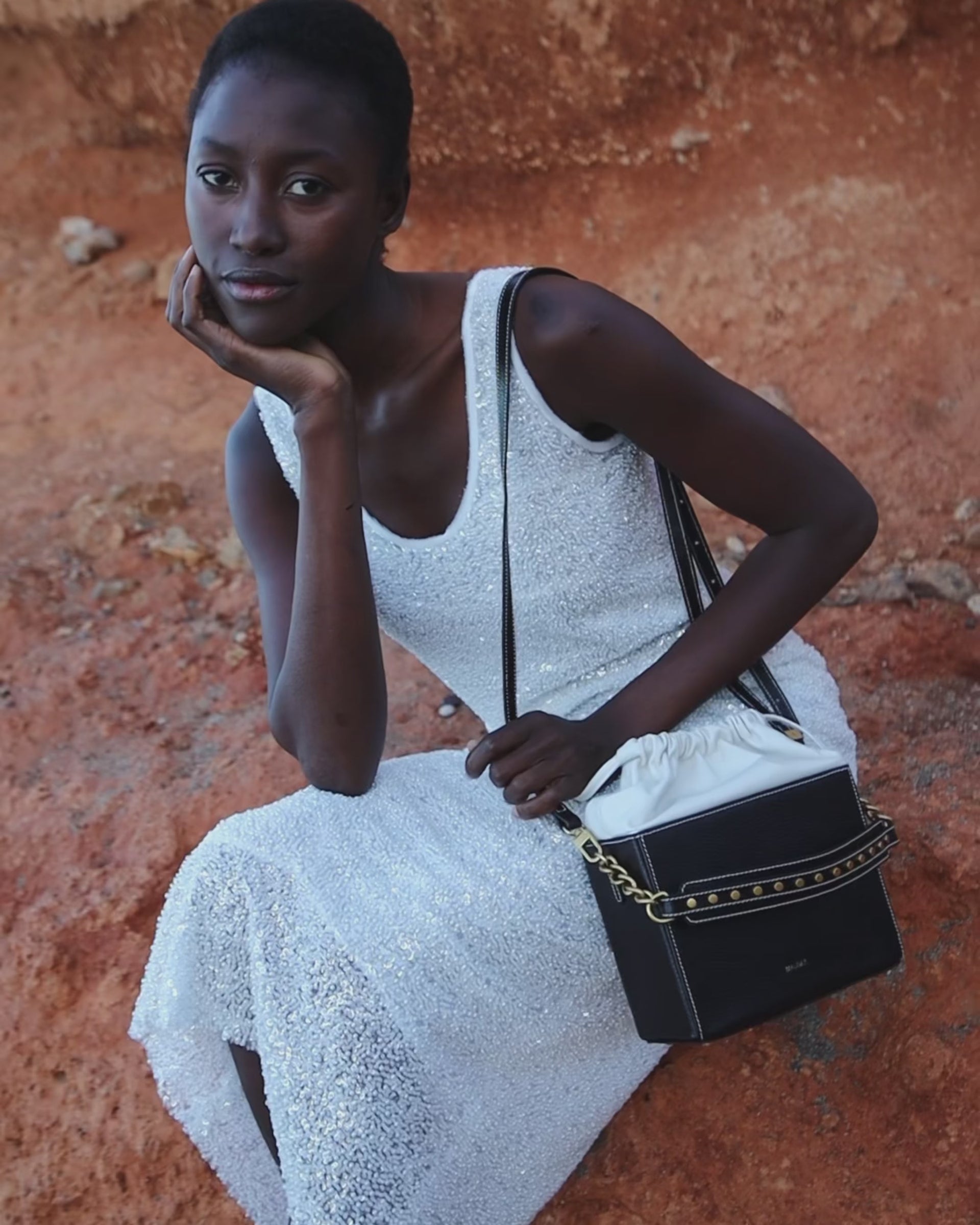 Video of the Colombo black and white suede leather bag by Mauska. A high-end leather accessory designed in San Sebastián and handcrafted in the workshops of Ubrique, Spain. Highlights the premium suede texture and contemporary designer silhouette